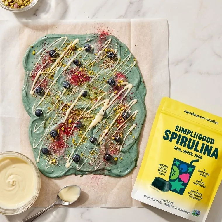 Spirulina yogurt bowl with fresh fruit and pouch